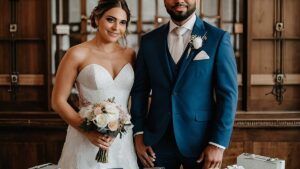 Nuotaka ir jaunikis stovi priešais stalą, nukrautą unikaliomis ir suasmenintomis vestuvinėmis dovanomis iš savo artimųjų.